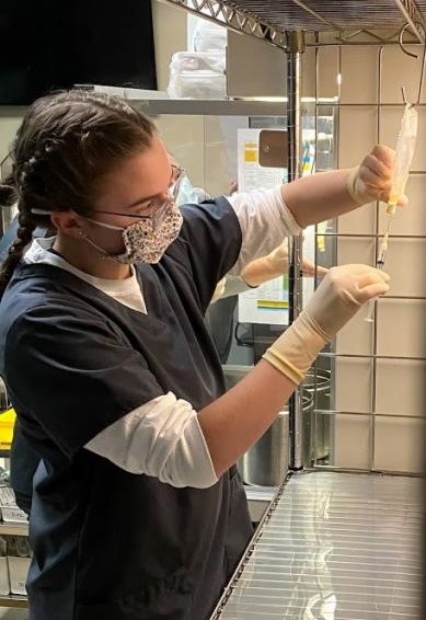 Pharmacy technician measures a dose