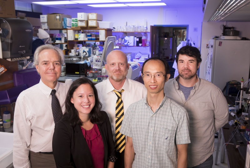 Five researchers pose for a group portrait in the Vickers Lab at Vanderbilt University Medical Center 