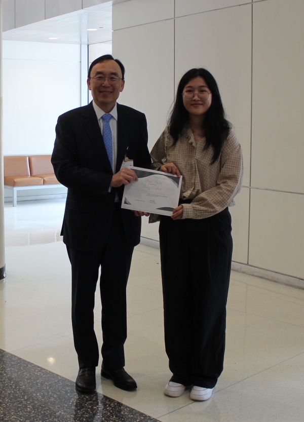 Yu Shyr and best poster winner Jia Li pose for a photo at the 20th anniversary celebration poster session