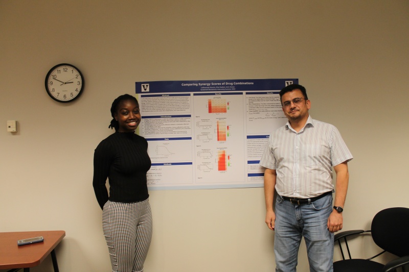 LaShawnda Stevens and Amir Asiaee in front of their poster