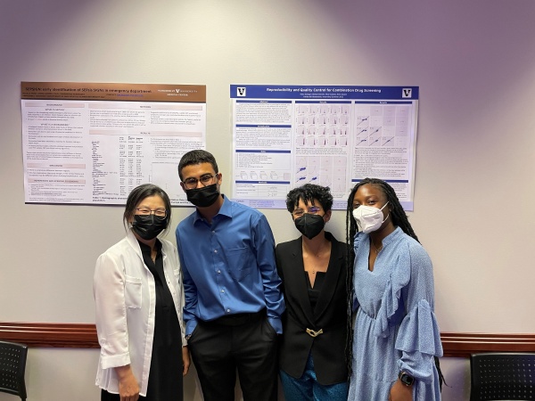 Leena Choi and interns stand in front of the scientific posters that reflect their work this summer 