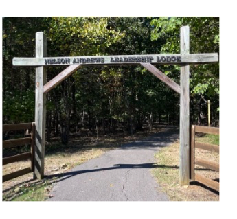 Wood rectangular arch with NELSON ANDREWS LEADERSHIP LODGE on the crossbar