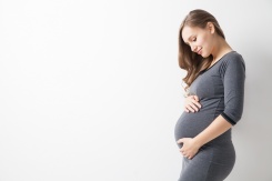 a photo of a pregnant woman holding her belly