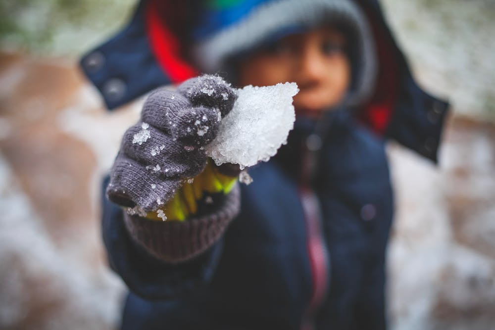 kid playing in snow