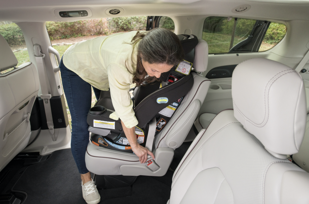 women installing car seat