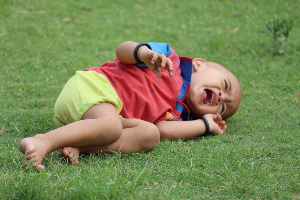 child on ground crying