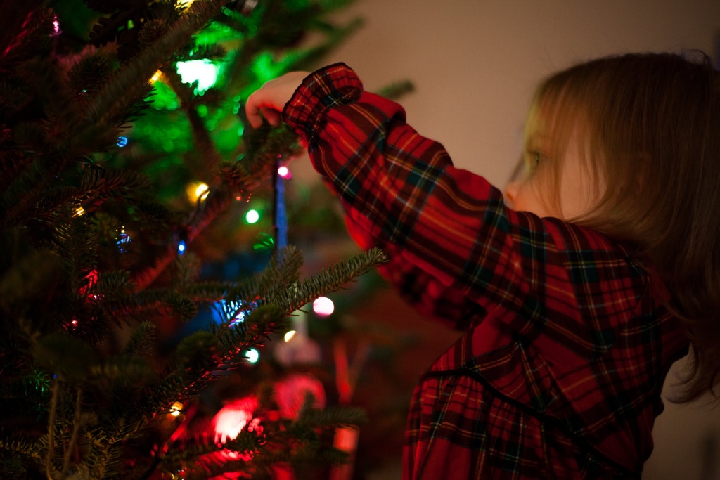 girl decorating the Christmas tree